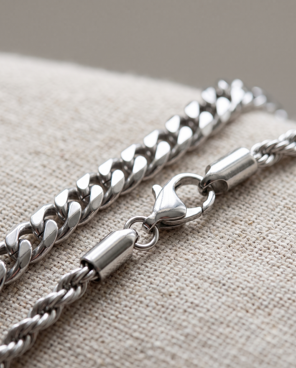 Close detail of the silver curb link, rope chain and lobster clasp