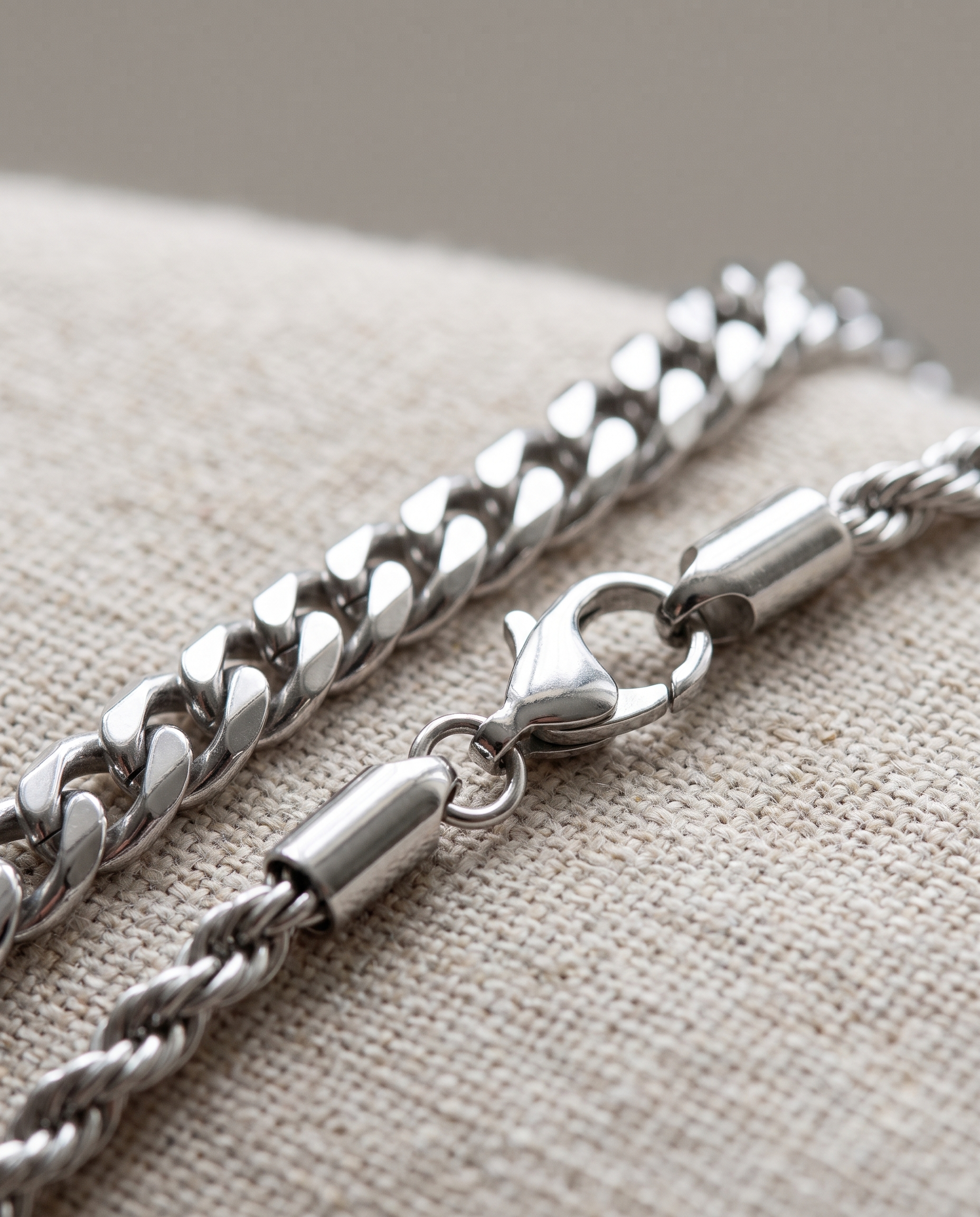 Close detail of the silver curb link, rope chain and lobster clasp