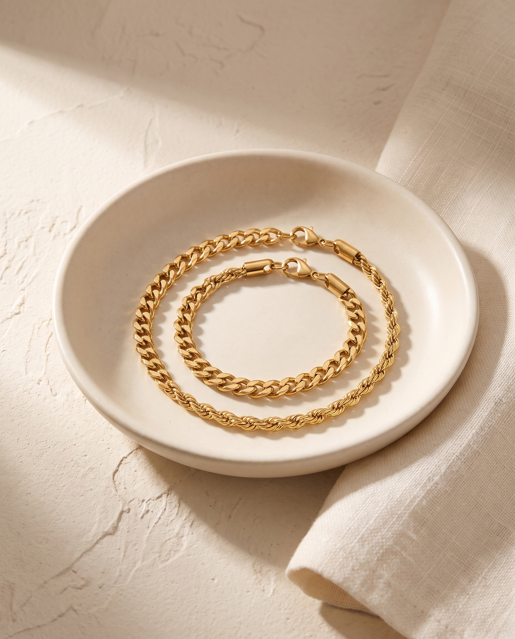 Sablon Stack in gold coiled in a bone ceramic dish