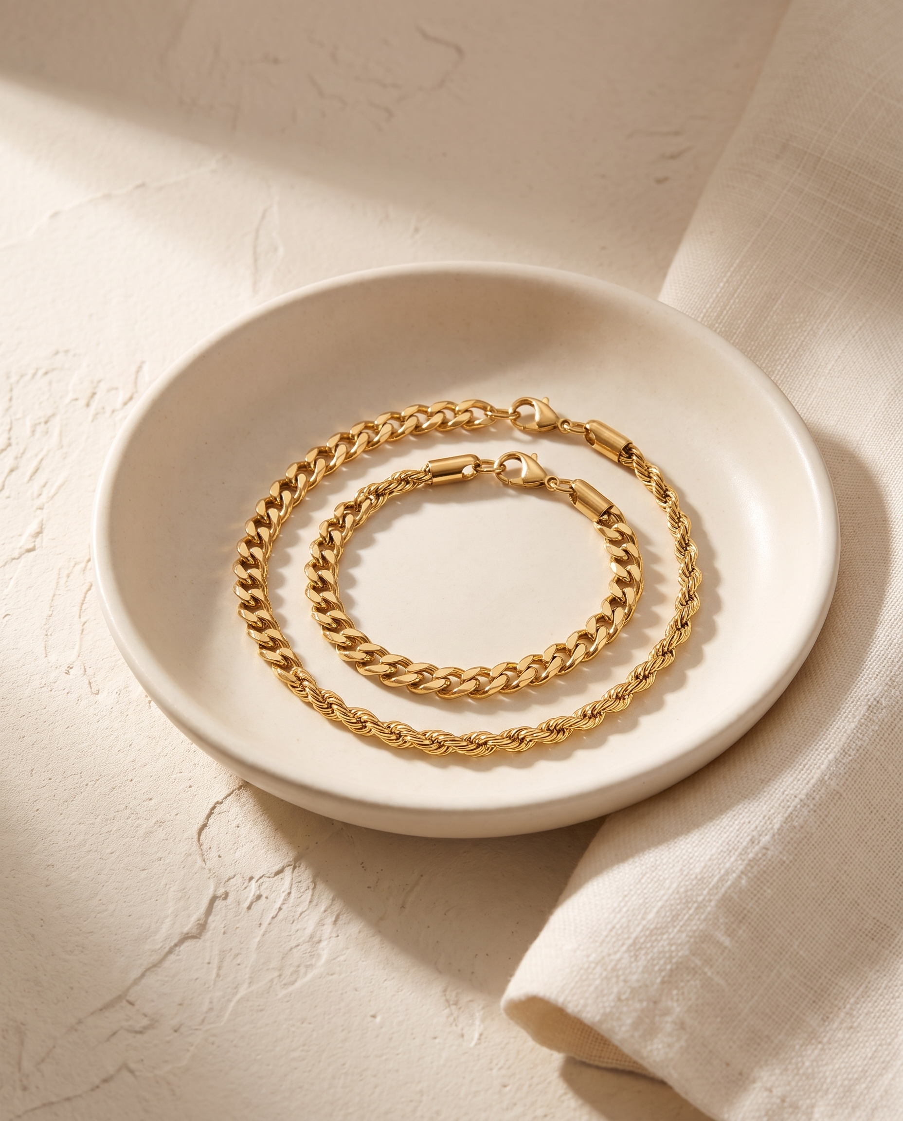 Sablon Stack in gold coiled in a bone ceramic dish