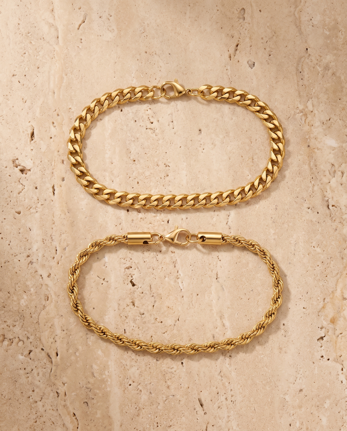 Sablon Stack in gold, flat lay of both bracelets on travertine