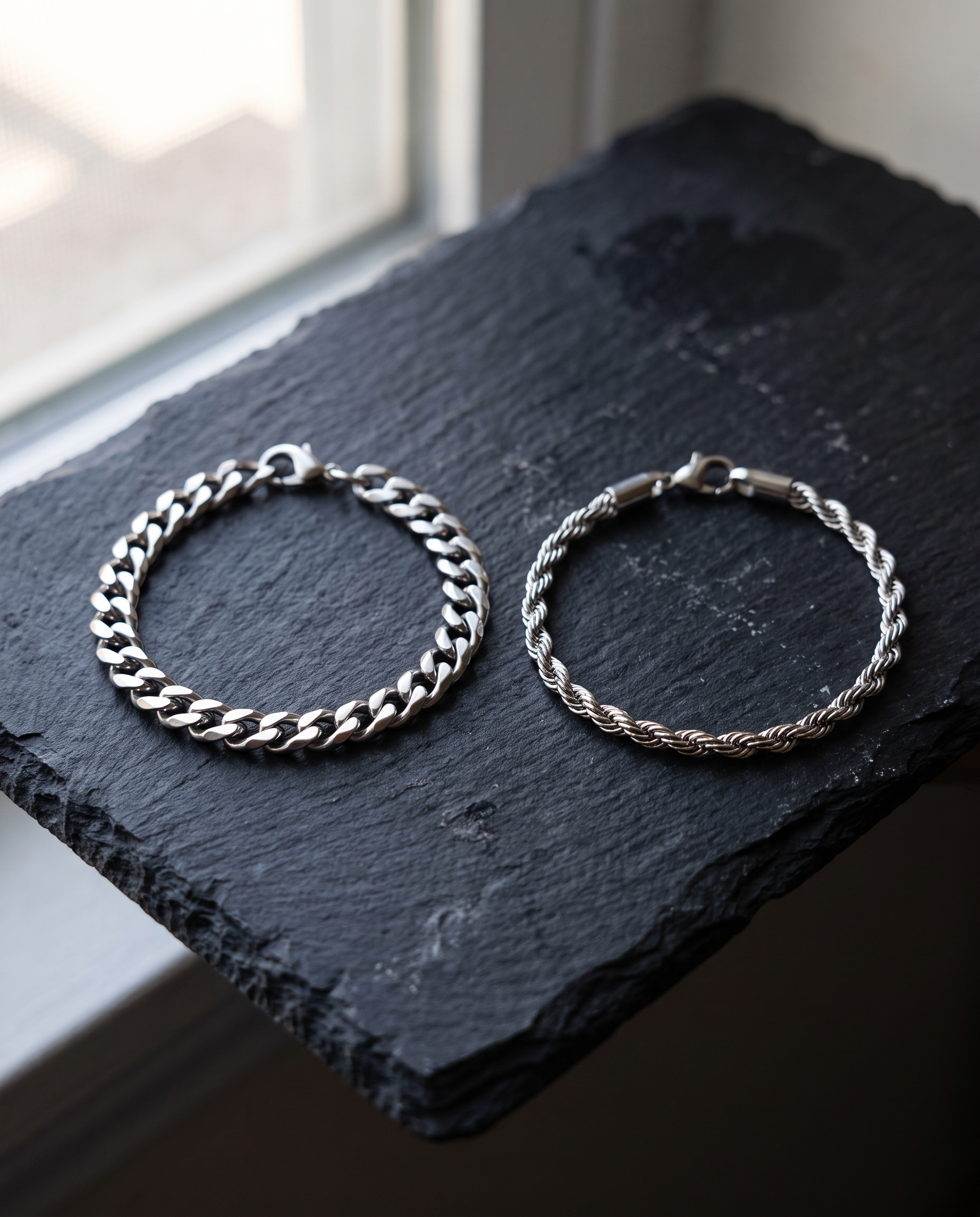 Sablon Stack in silver, both bracelets on dark slate by a window