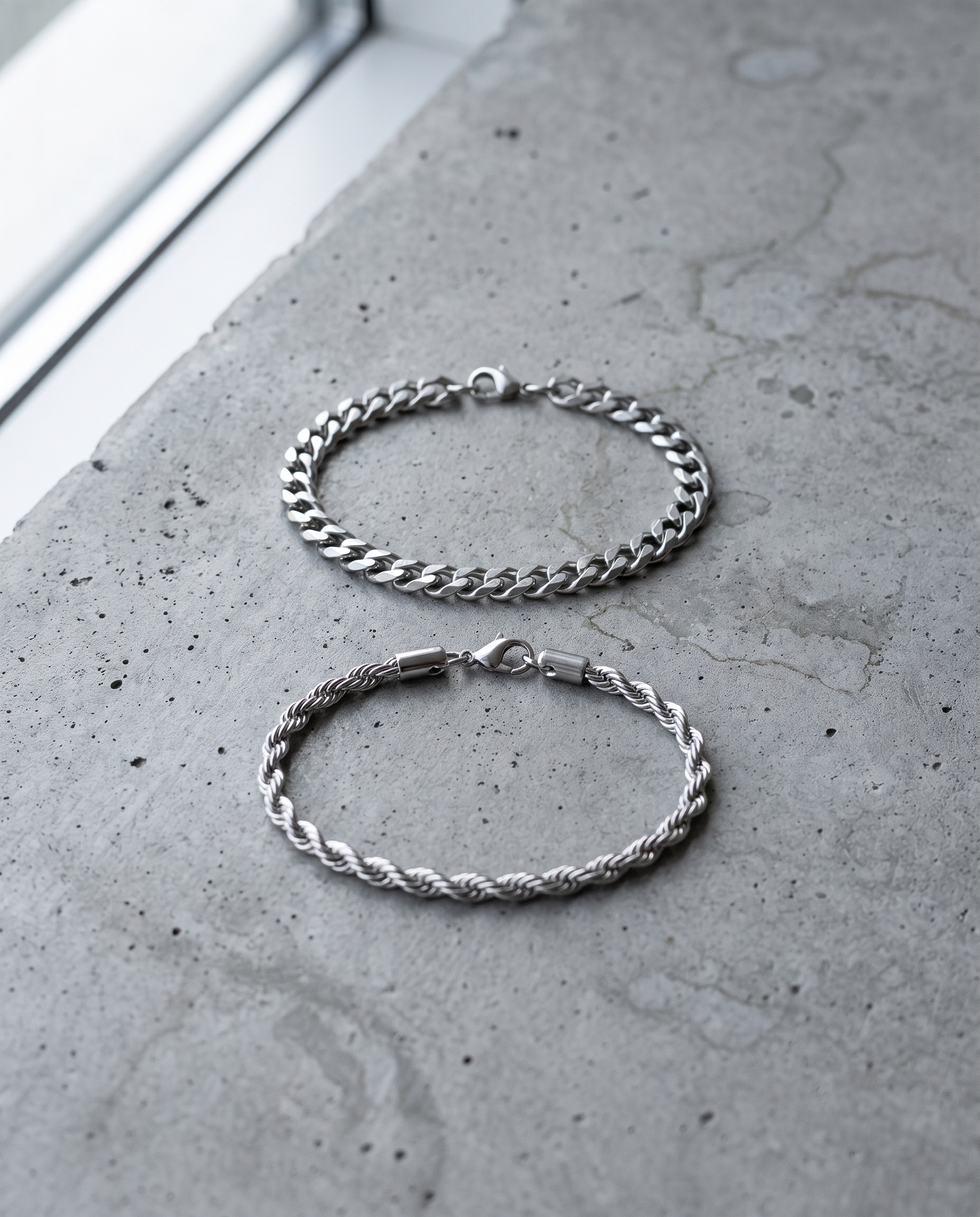 Sablon Stack in silver, both bracelets on grey concrete in window light